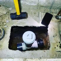 A pipe is being installed in a hole in the ground.