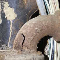 A close up of a statue of an elephant in front of a wall.