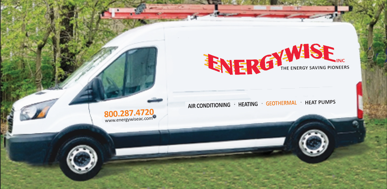 White EnergyWise service van with red ladder racks parked on grass near trees