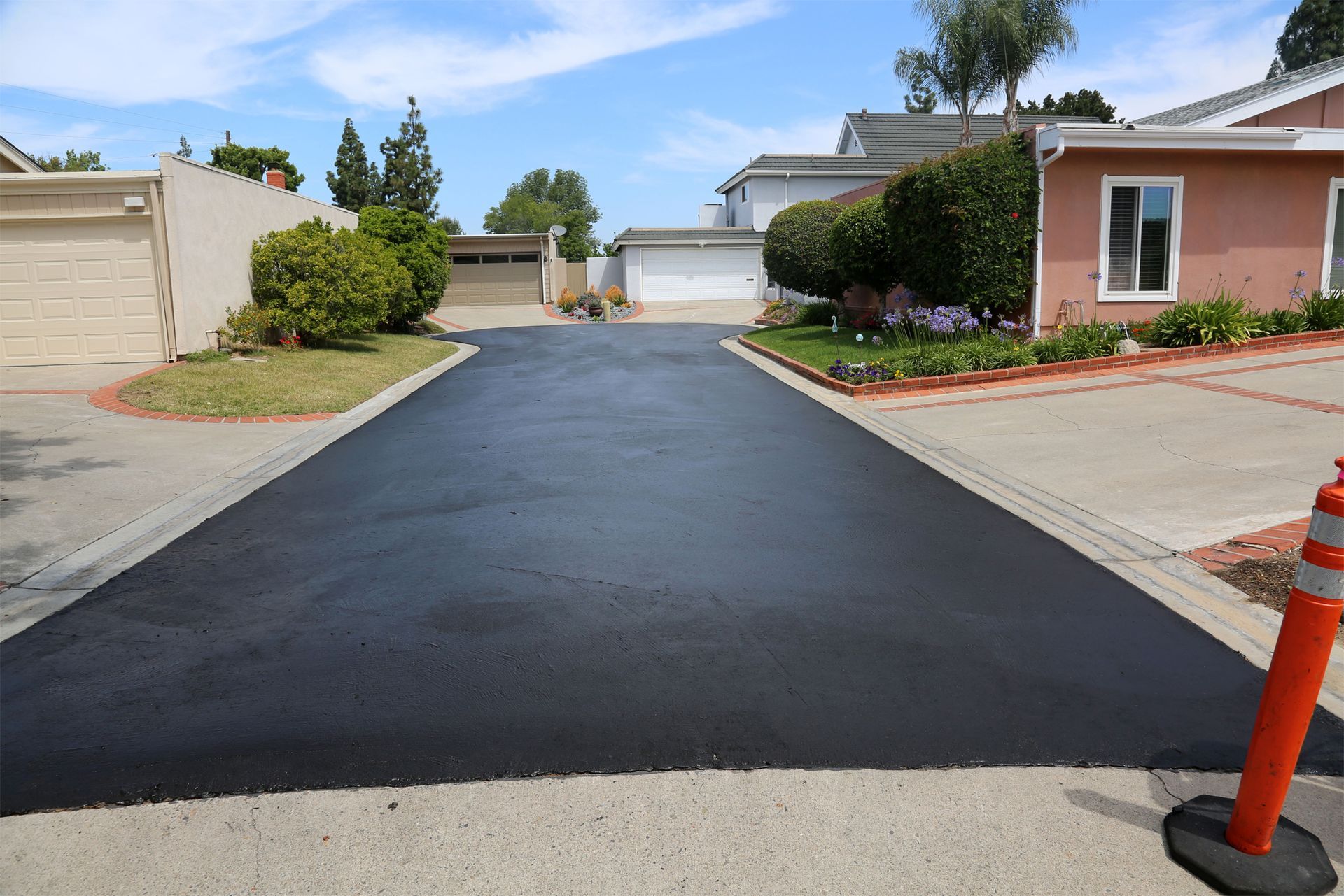 a newly paved driveway in a residential neighborhood