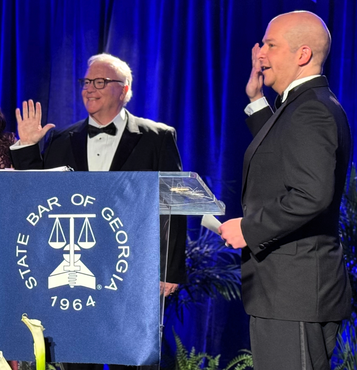 Two men standing behind a podium that says State Bar of Georgia 1964.