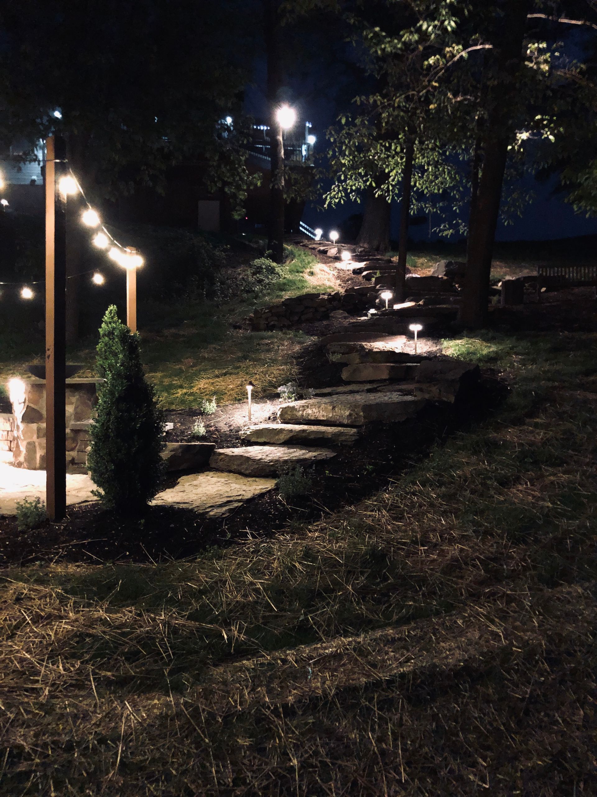A staircase with lights on it is lit up at night.