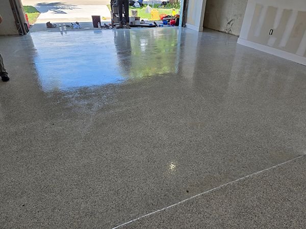 Polished concrete floor with a glossy, reflective surface in a garage or interior space.
