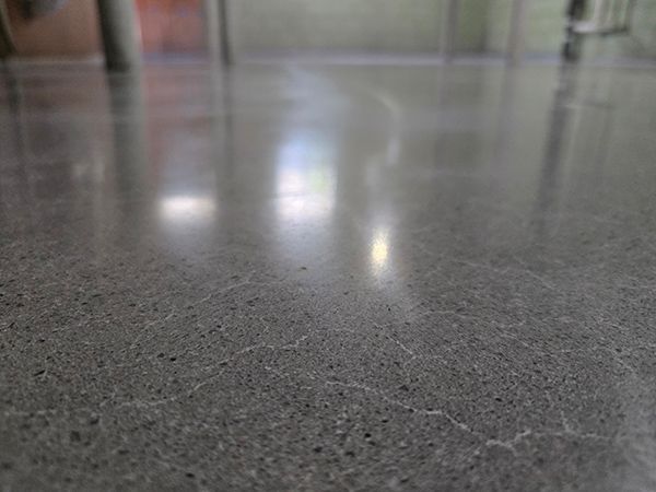 Polished concrete floor reflecting surrounding environment.