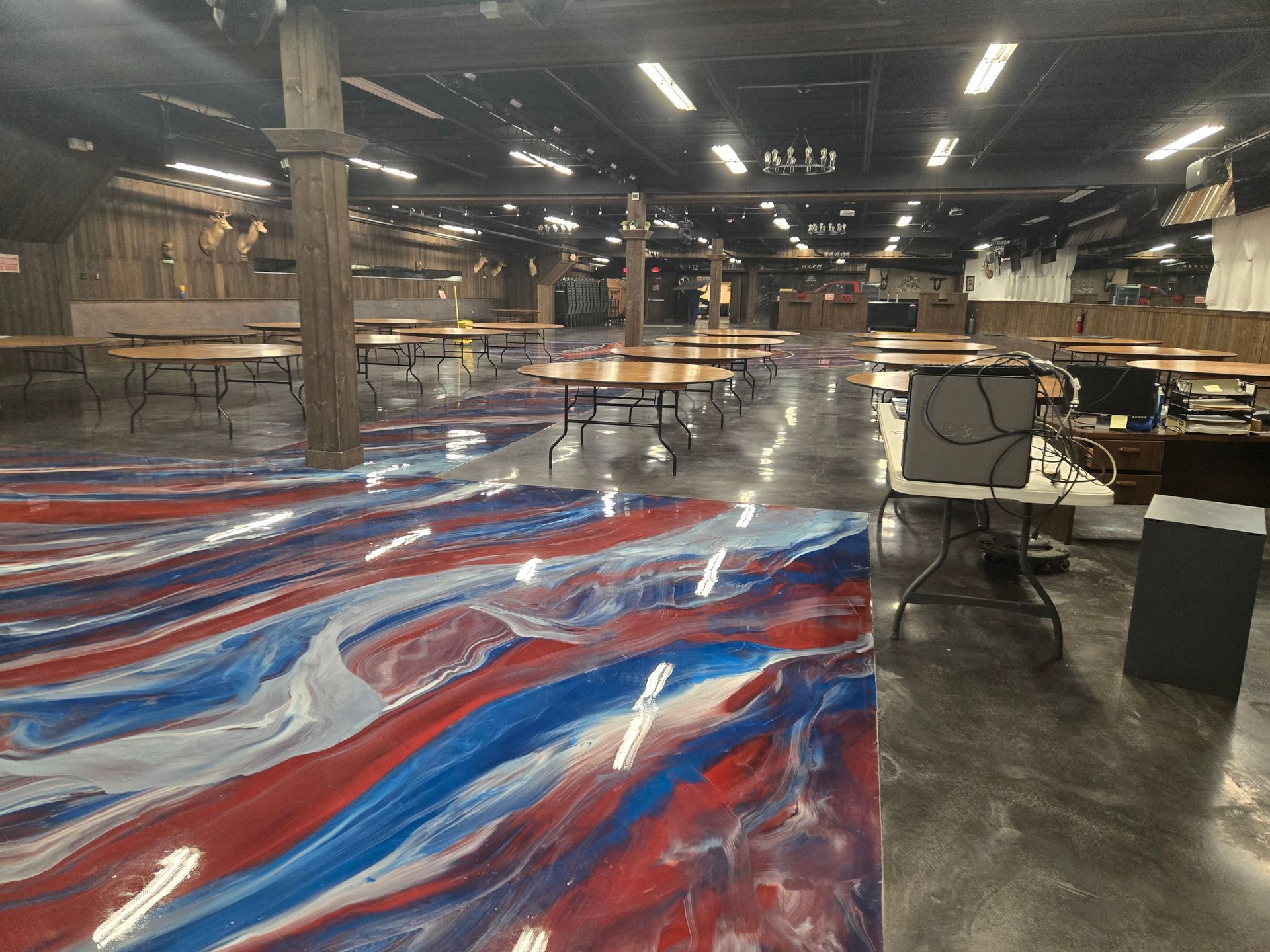 Wide shot of an empty hall with red, white, and blue epoxy flooring