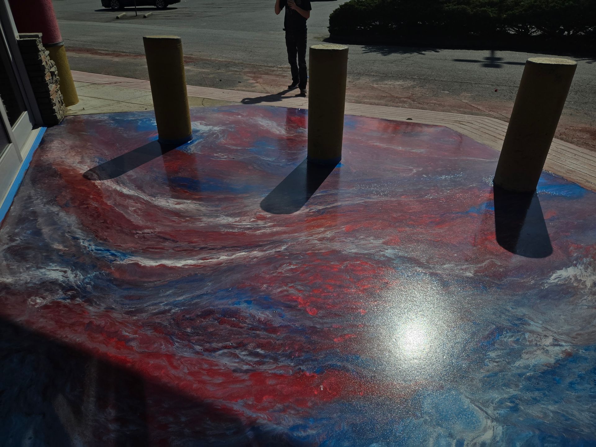 Entry way with red, white, and blue swirled epoxy finish floor