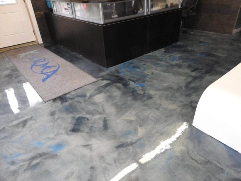 Metallic epoxy floor with blue and silver swirls