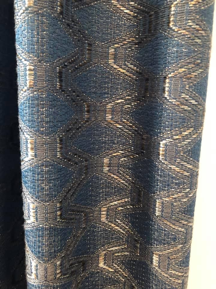 Blue and gold patterned woven fabric with repeating geometric designs