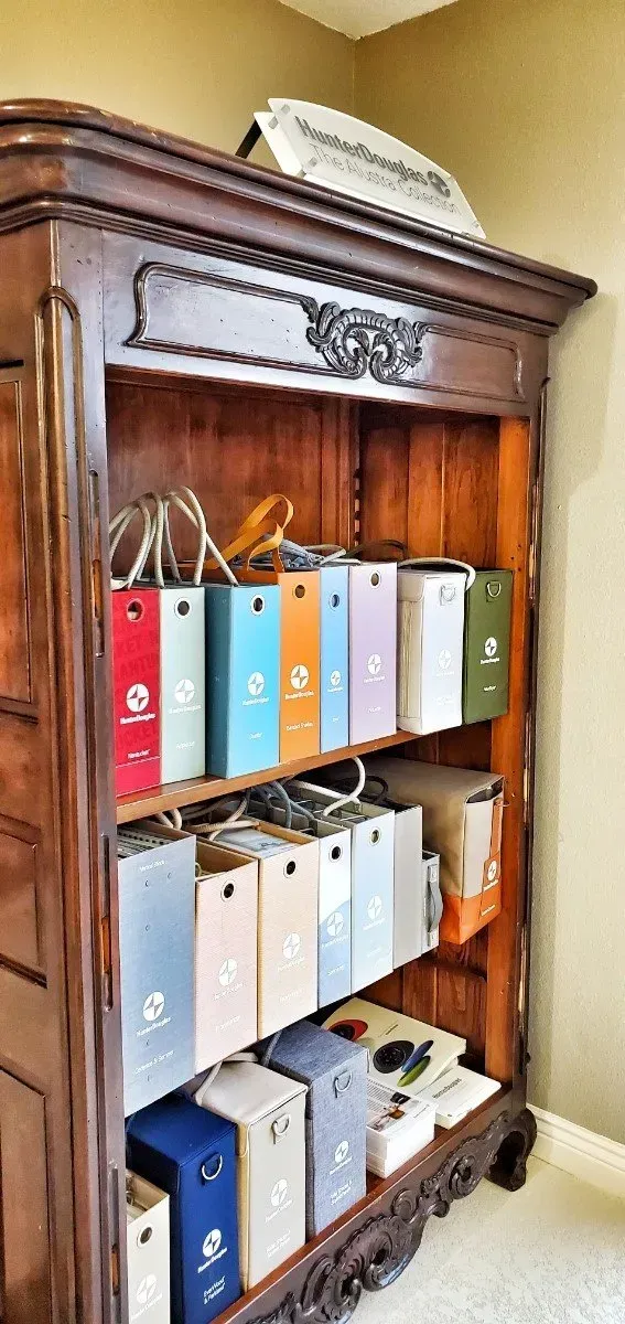 Ornate wooden cabinet with shelves of colorful binders and files inside
