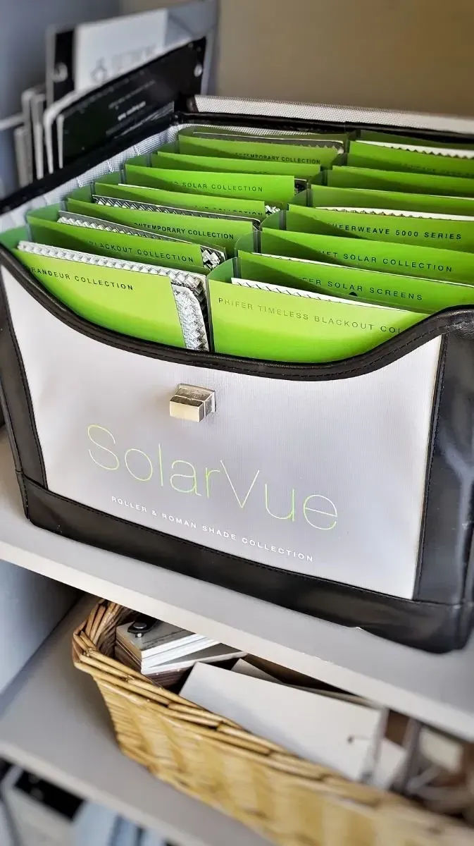 Open file organizer with bright green dividers and labeled front pocket on a shelf