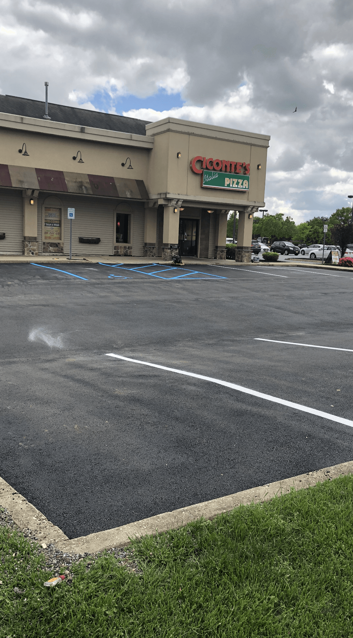 A commercial building with a parking lot in front of it