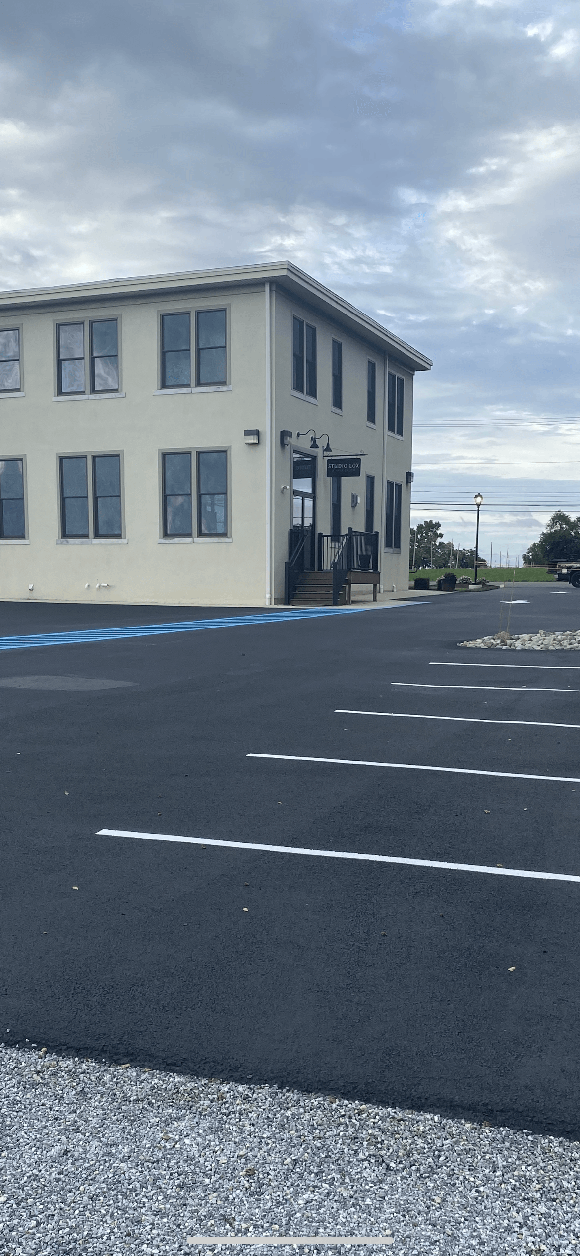 A large white building with a parking lot in front of it