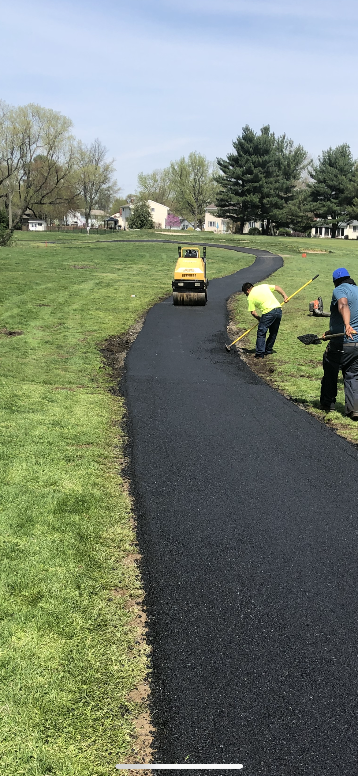 A couple of men are working on a road