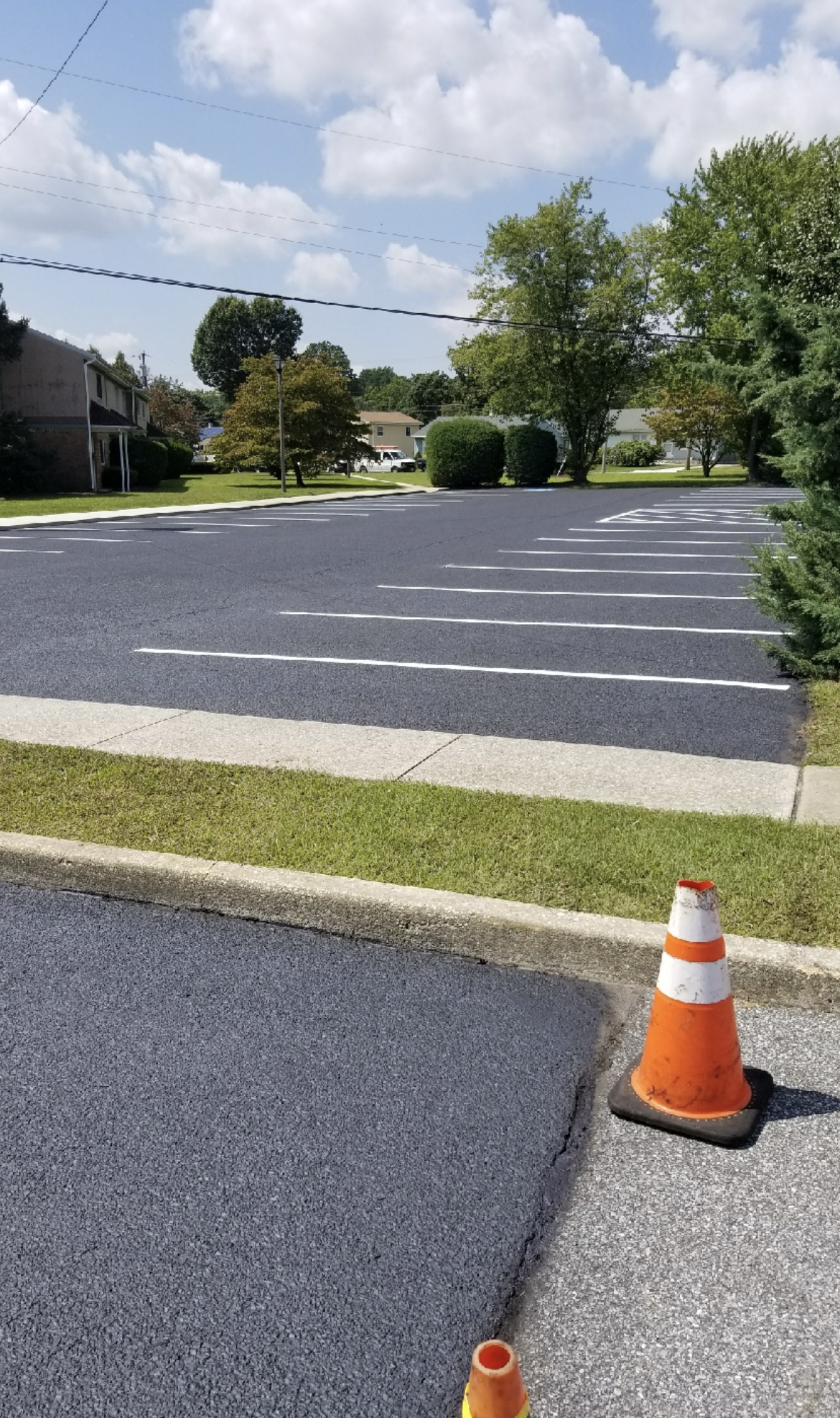 A parking lot with a cone on the side of the road