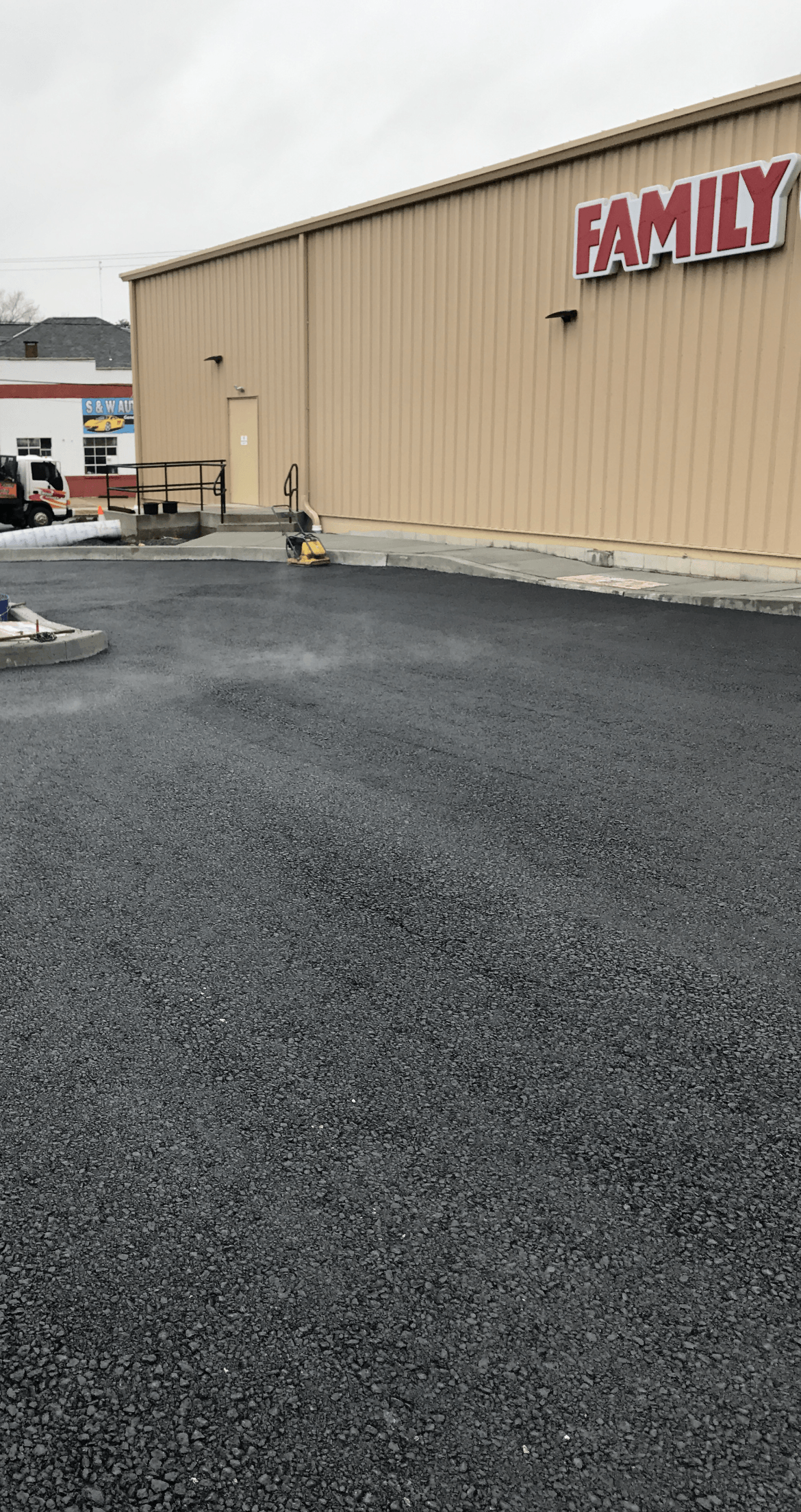 A large commercial building with a lot of parking space in front of it