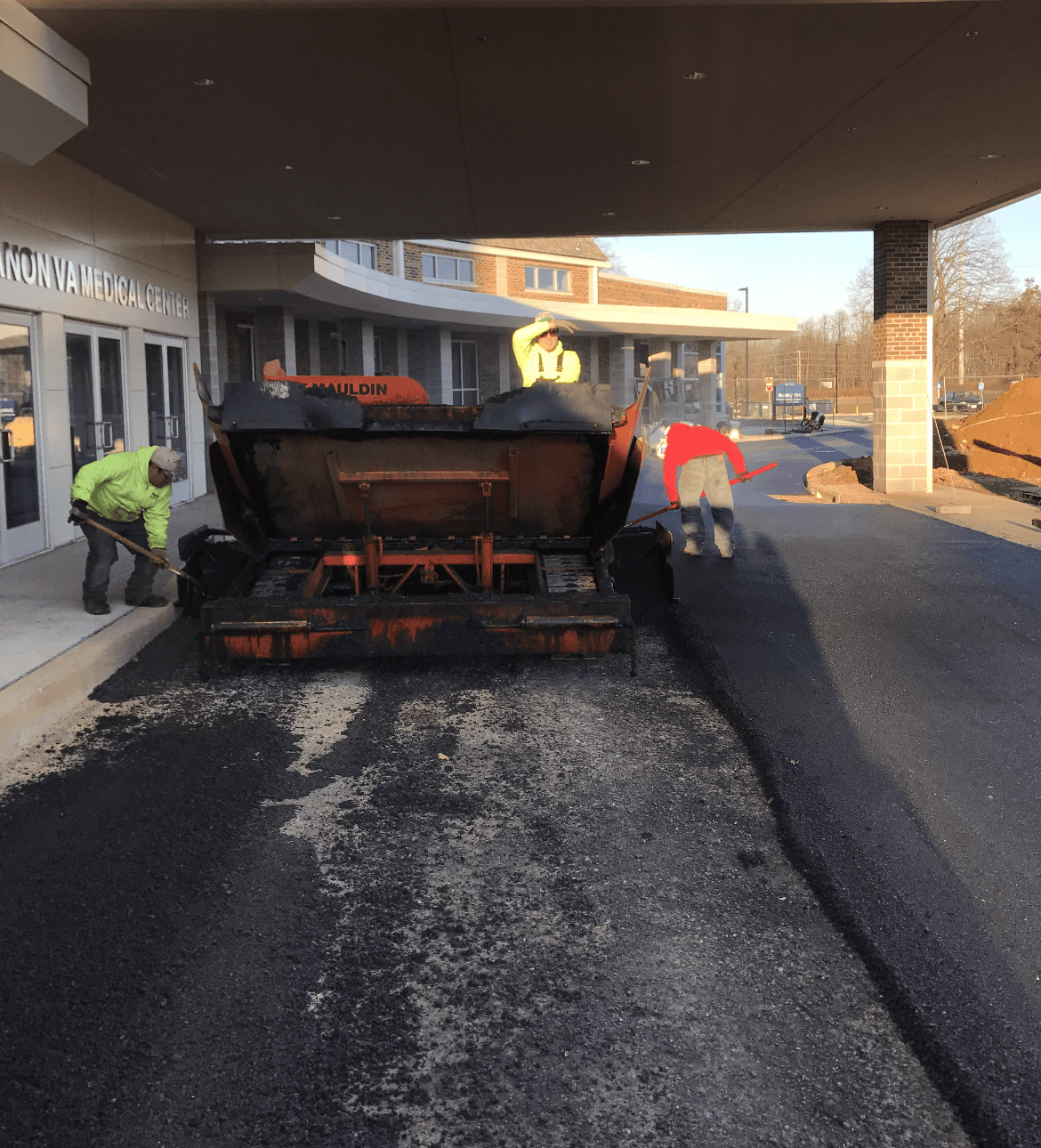Men working on an asphalt road