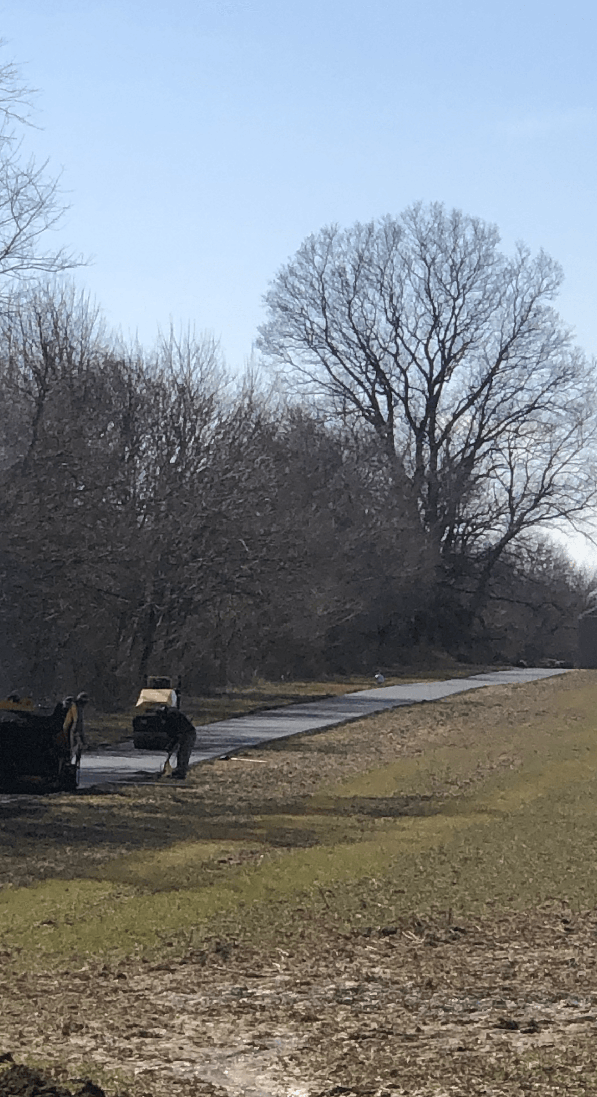 Asphalt road next to a field