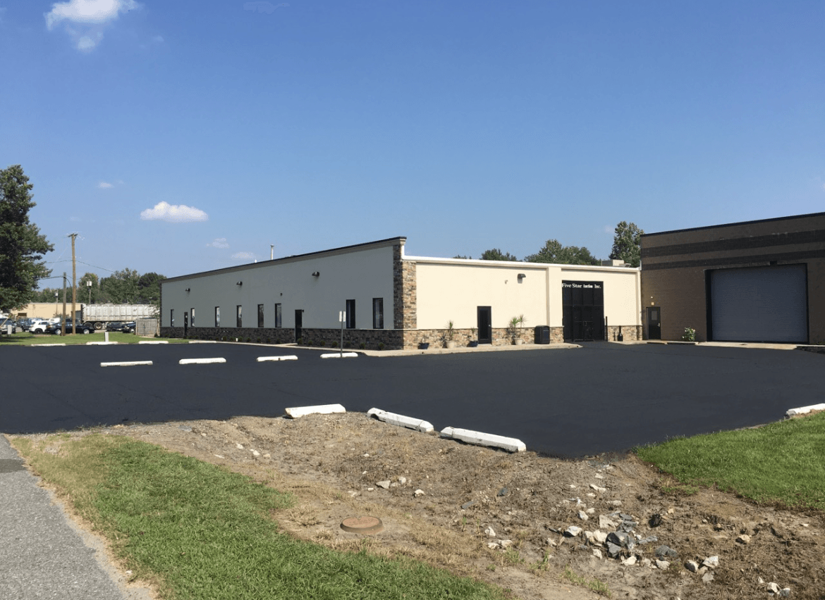 A building with a lot of parking spaces in front of it