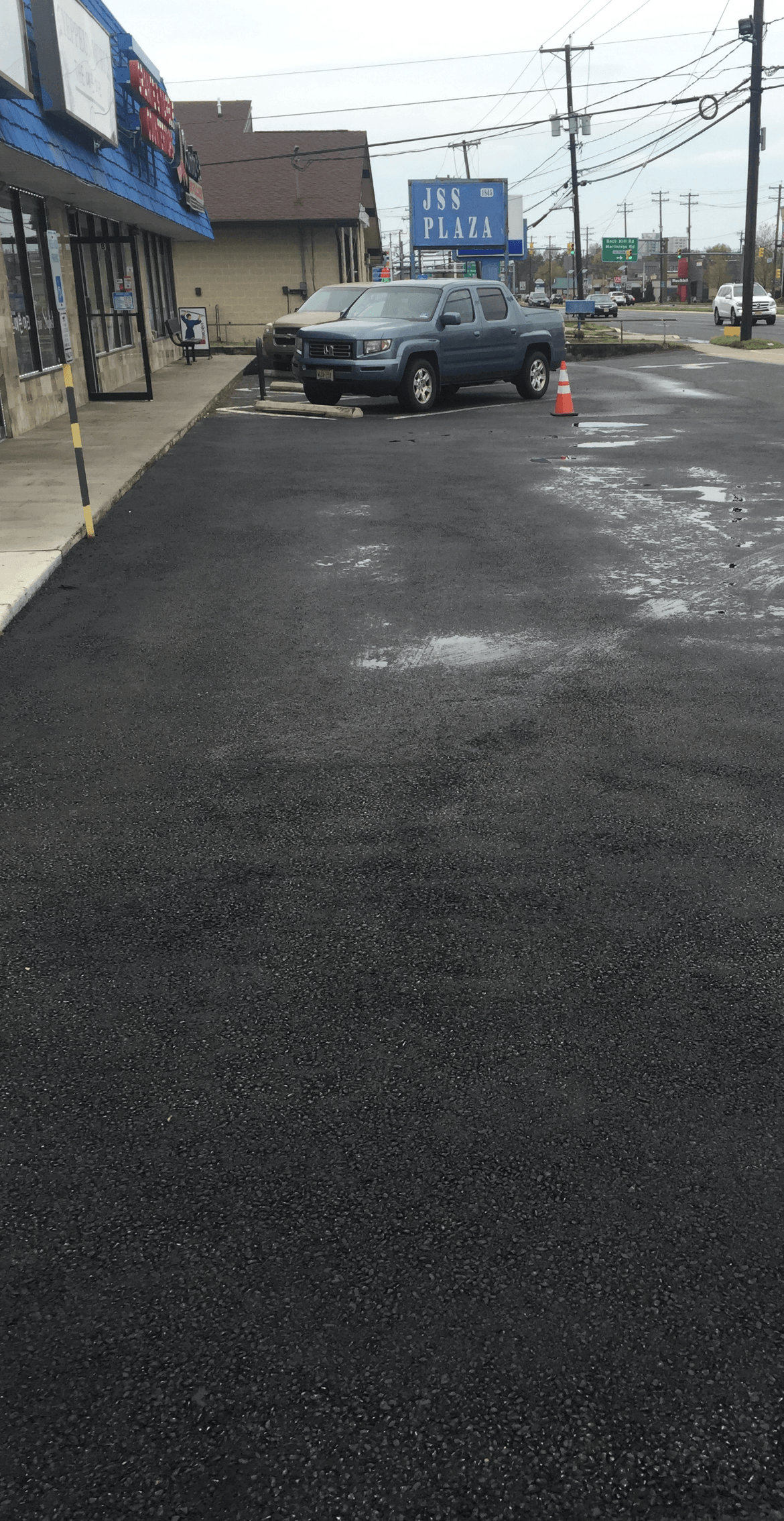 A parking lot with cars parked in front of a building