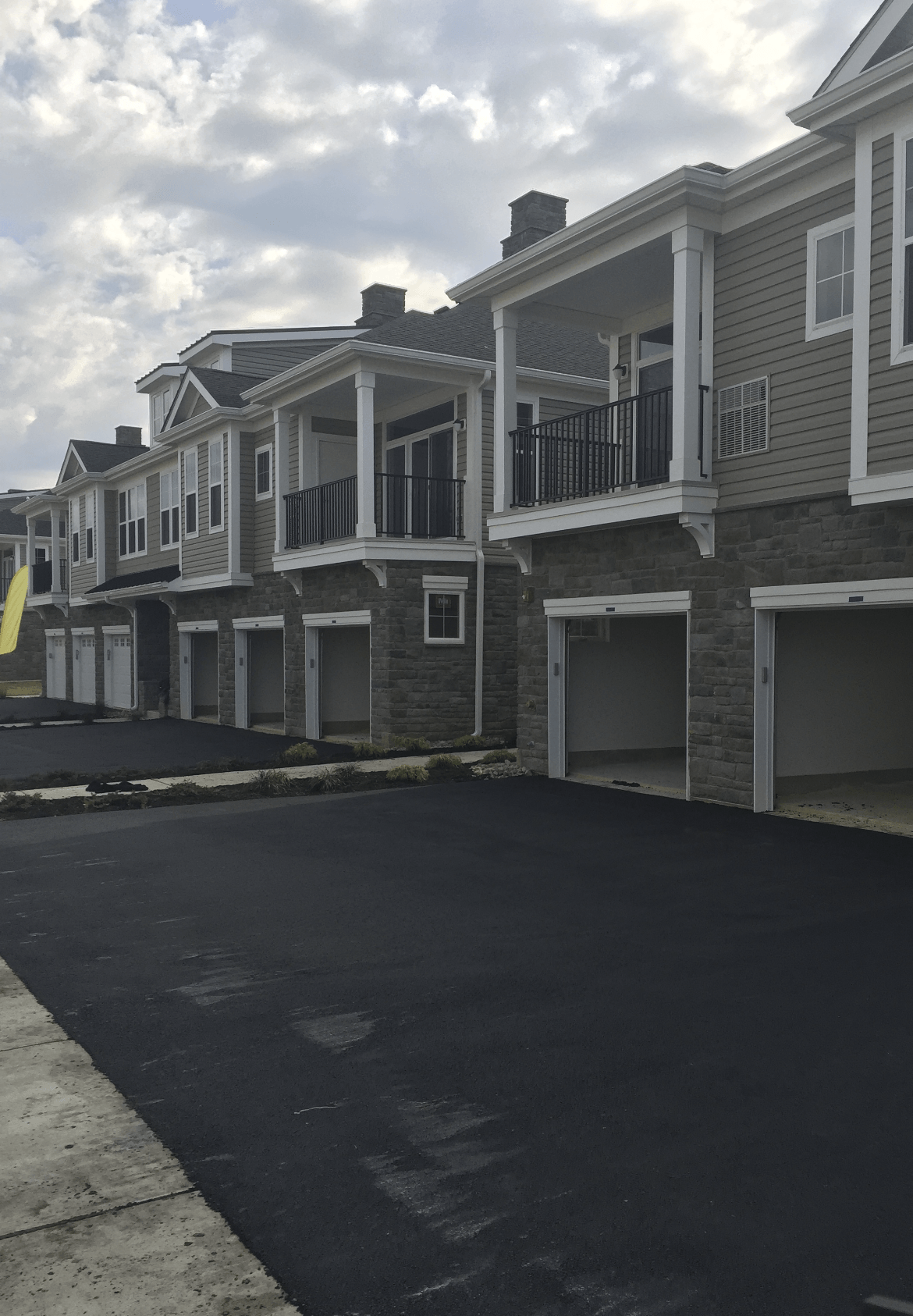 A row of apartment buildings with garages and balconies