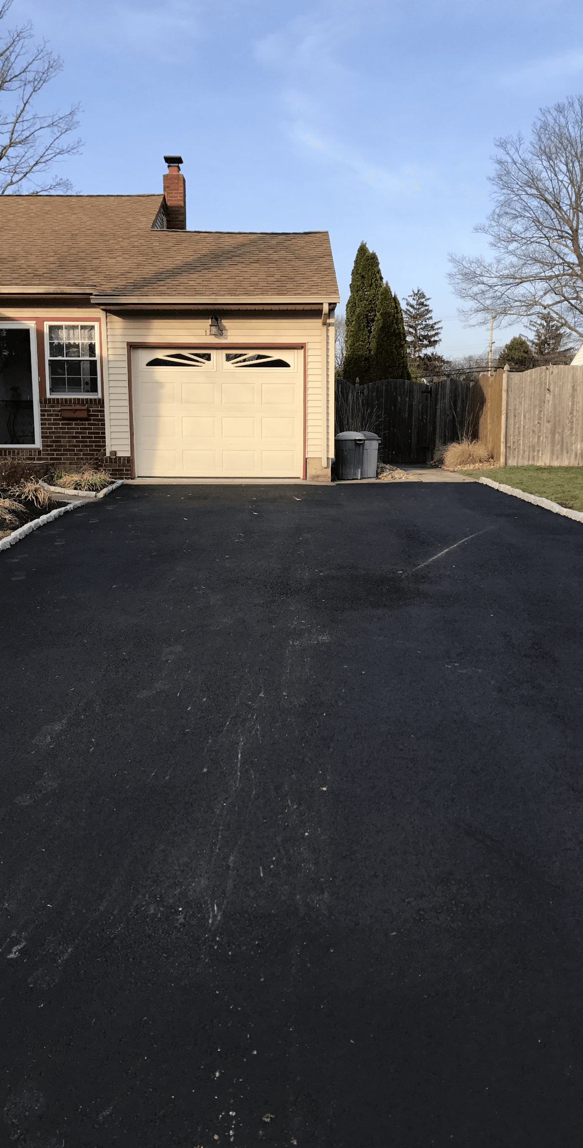 A house with a garage and a driveway in front of it