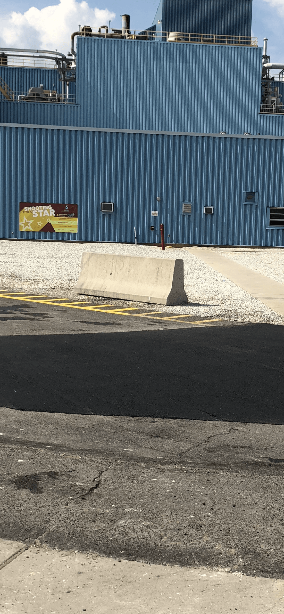 A large blue building next to a road