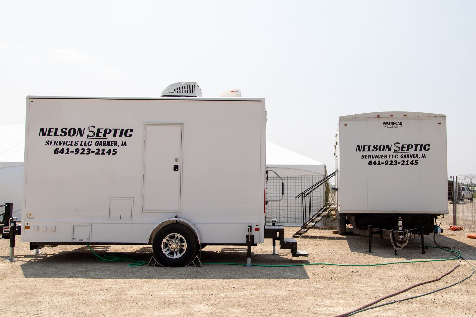 Two white trailers with the word septic on them