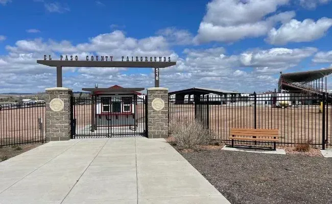 A gated entrance with a sign reading 