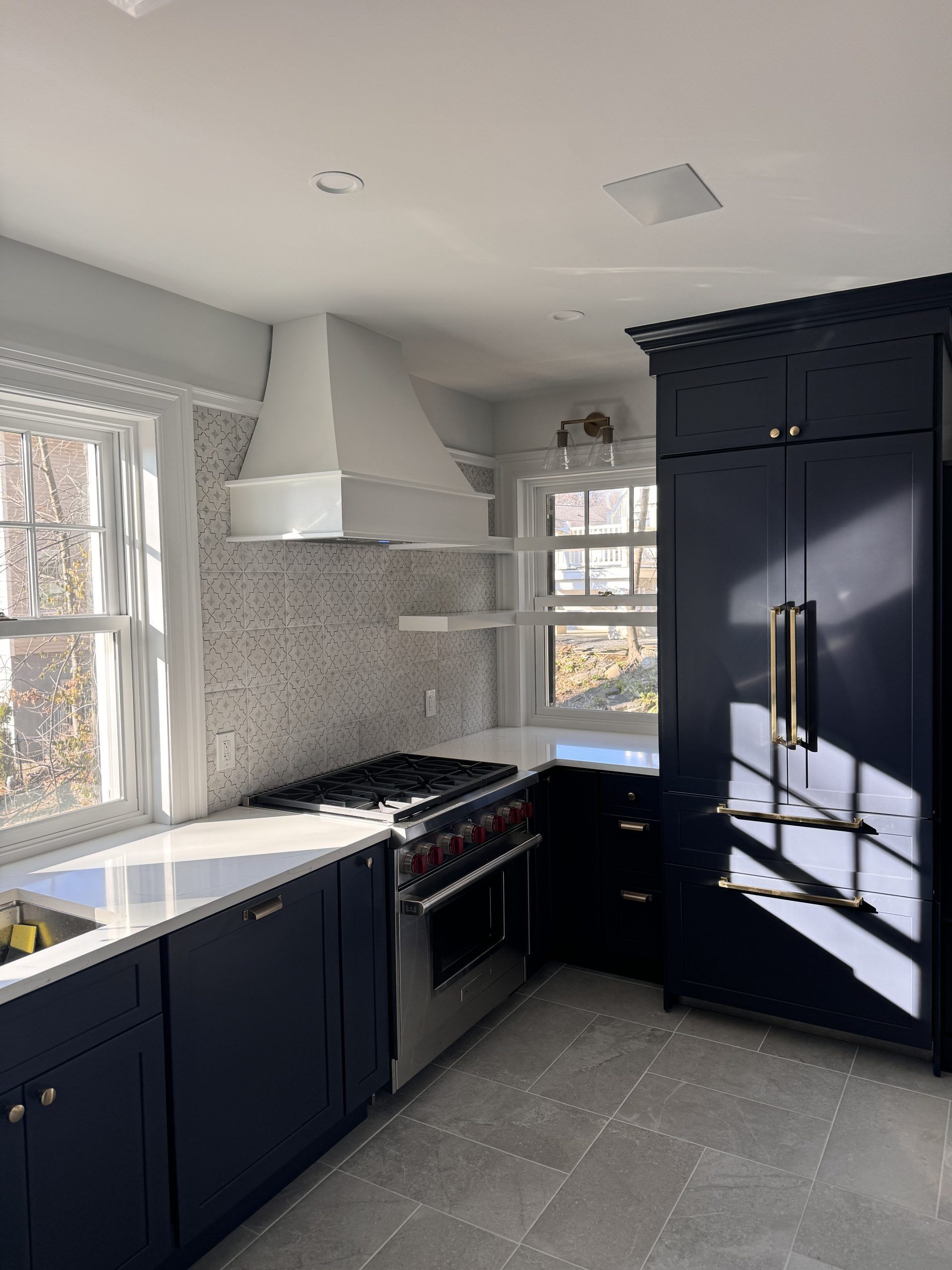 Kitchen with light brown cabinets, white countertops, and stainless steel appliances.