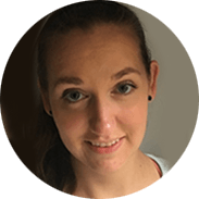 Woman with light brown hair smiles, looking towards the camera.