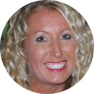 Woman with curly blonde hair smiling at the camera.