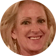 Smiling woman with blonde hair, visible earrings, and fair skin.