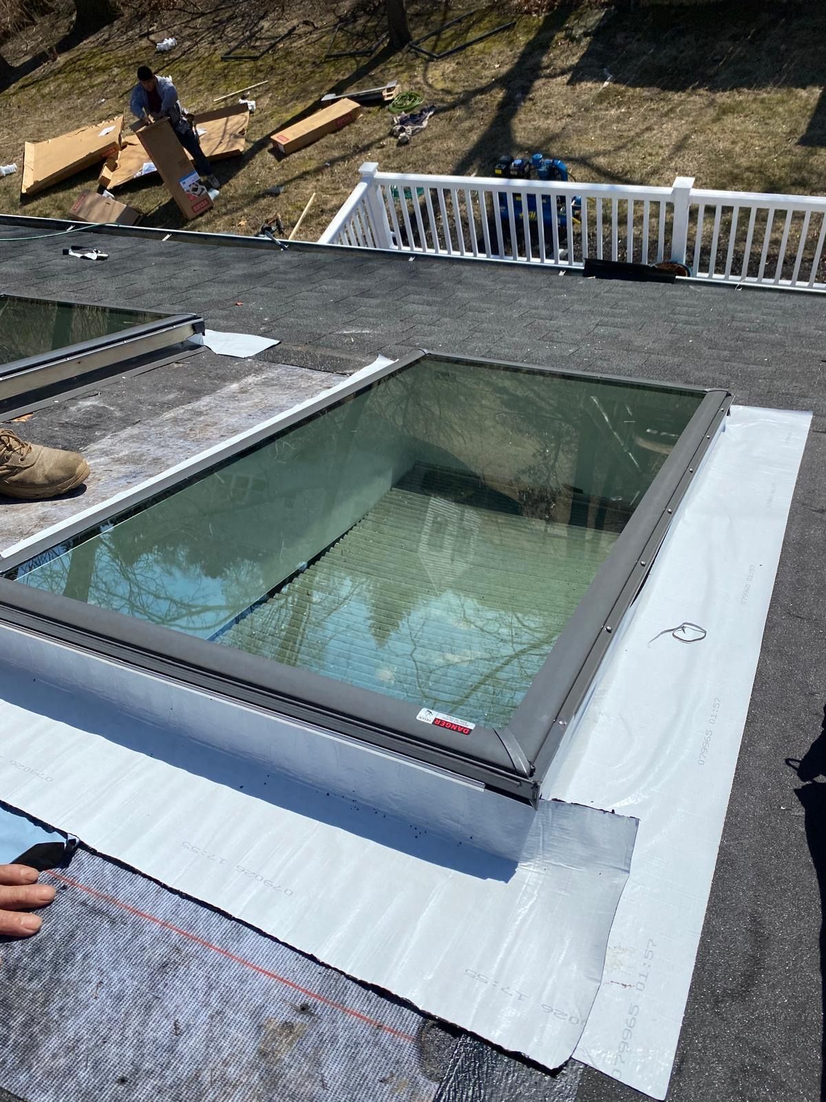 A skylight is being installed on the roof of a house.