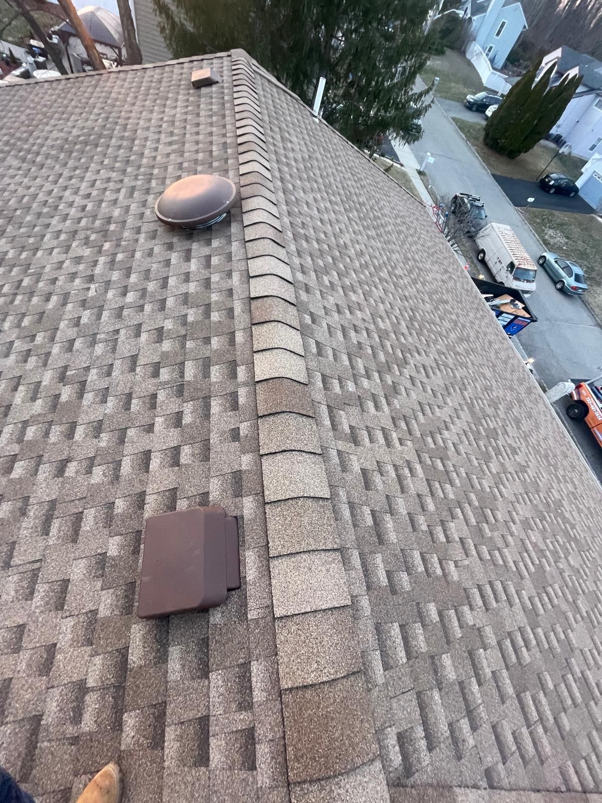 A person is standing on the roof of a house.