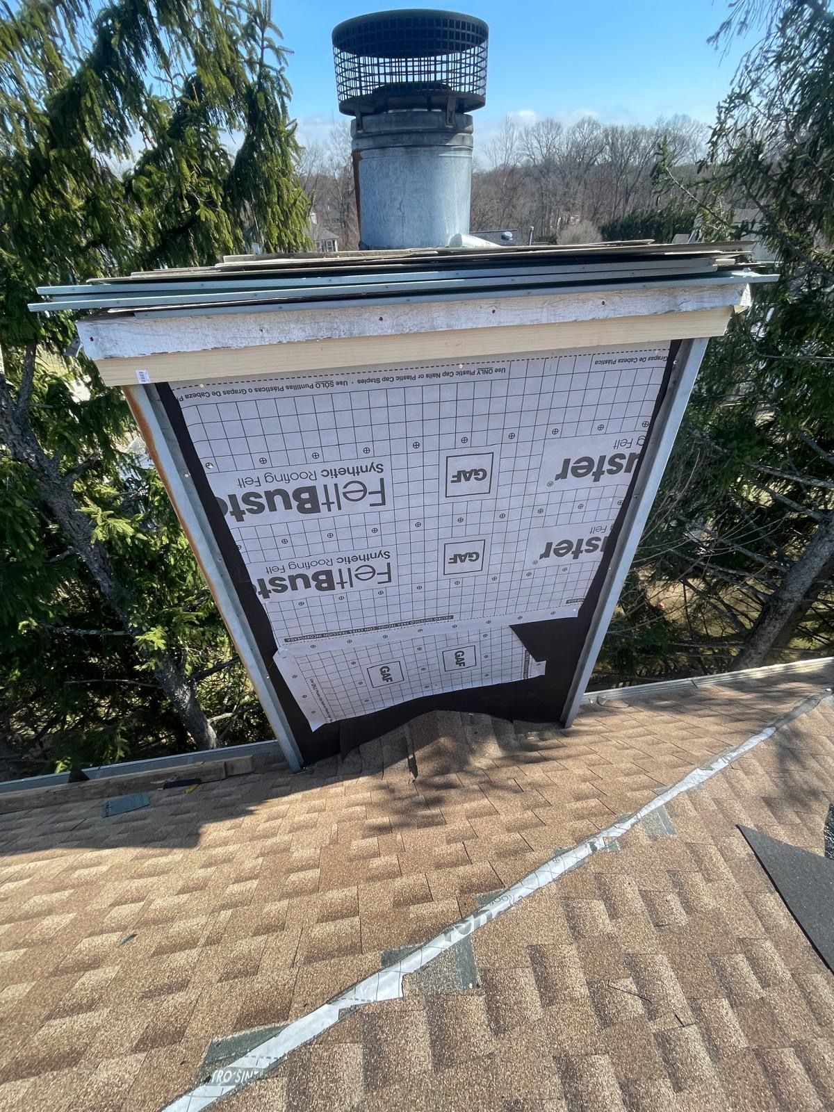 A chimney is sitting on top of a roof.