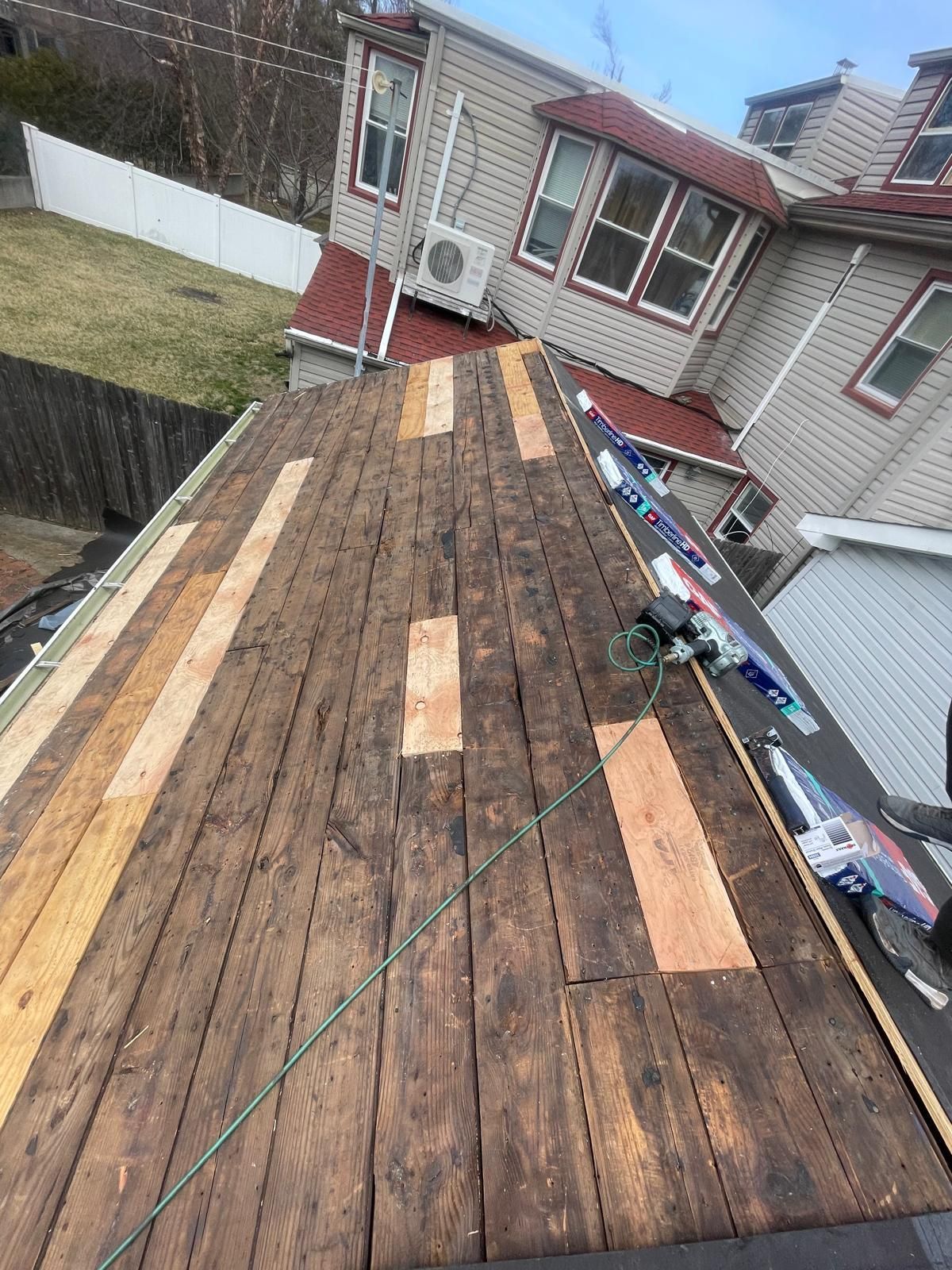 A wooden roof is being repaired on a house.