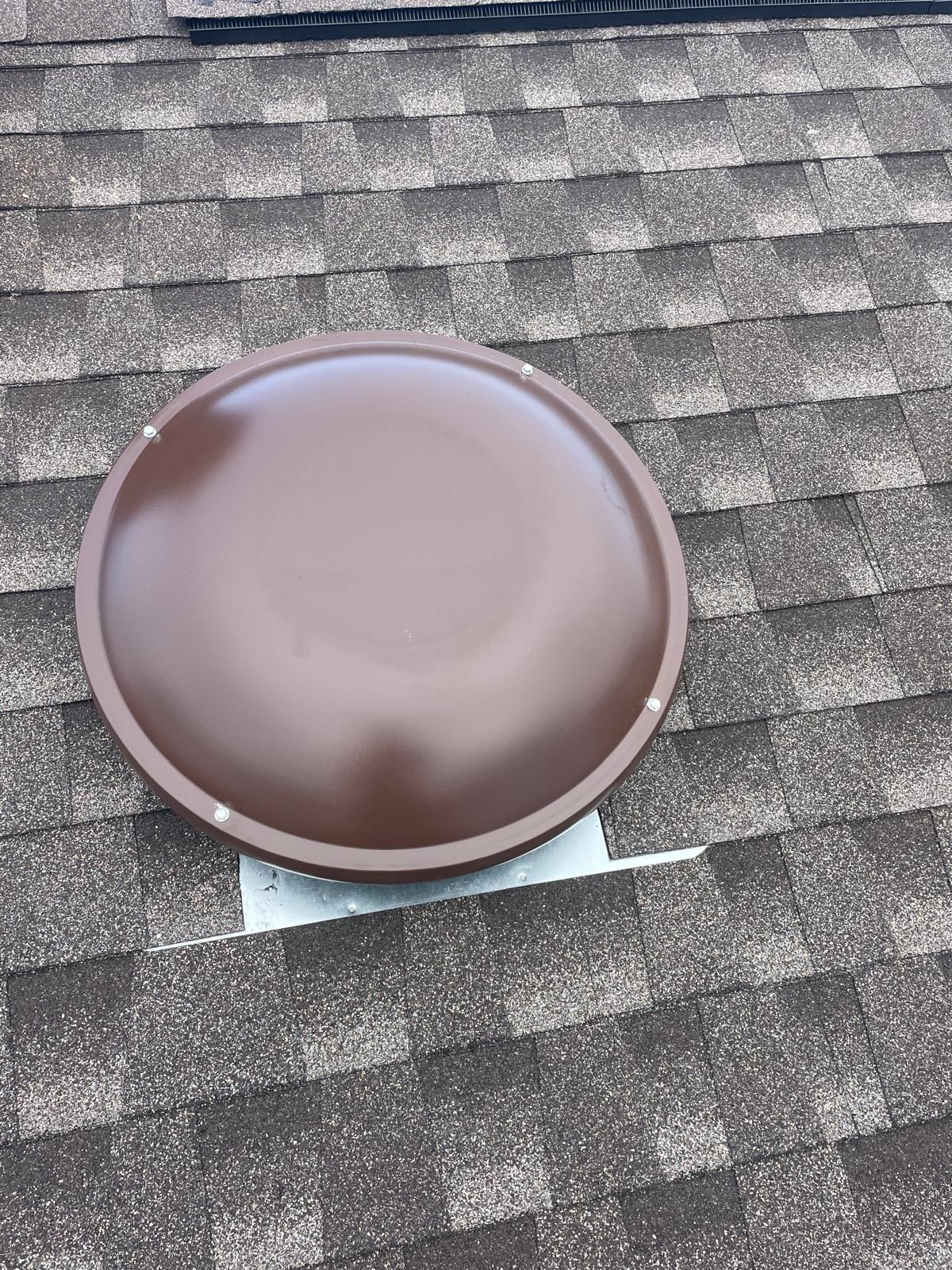A brown dome is sitting on top of a roof.