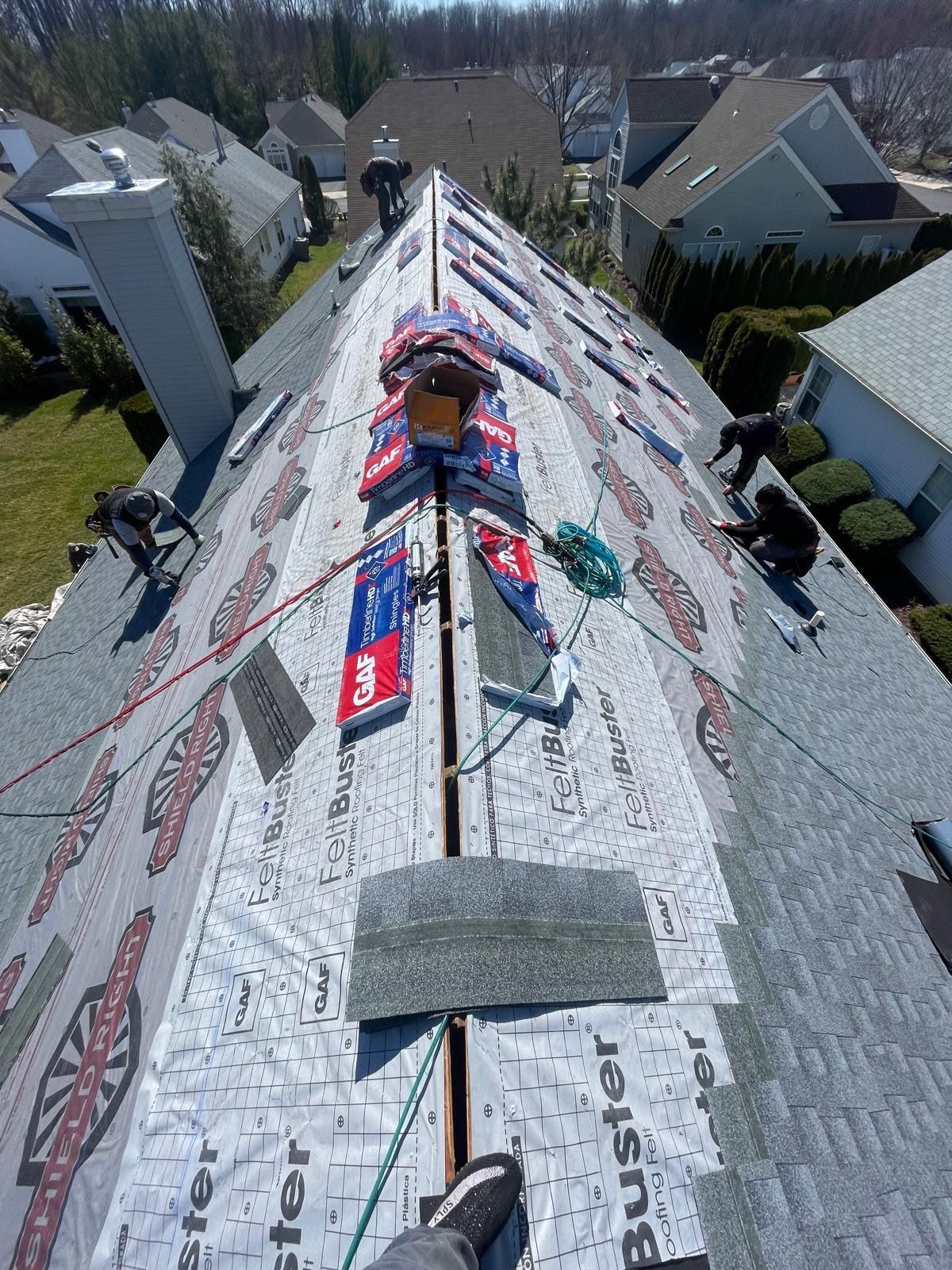 A person is standing on the roof of a house.