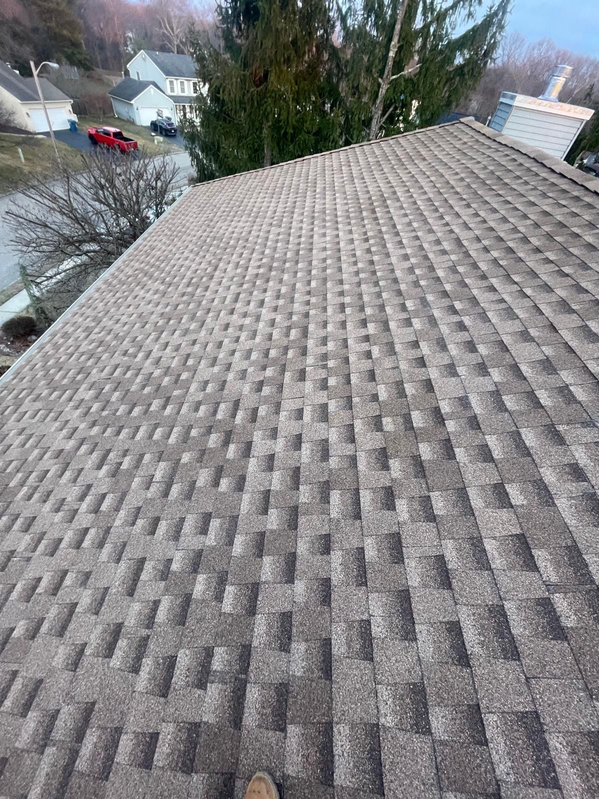 A person is standing on the roof of a house.