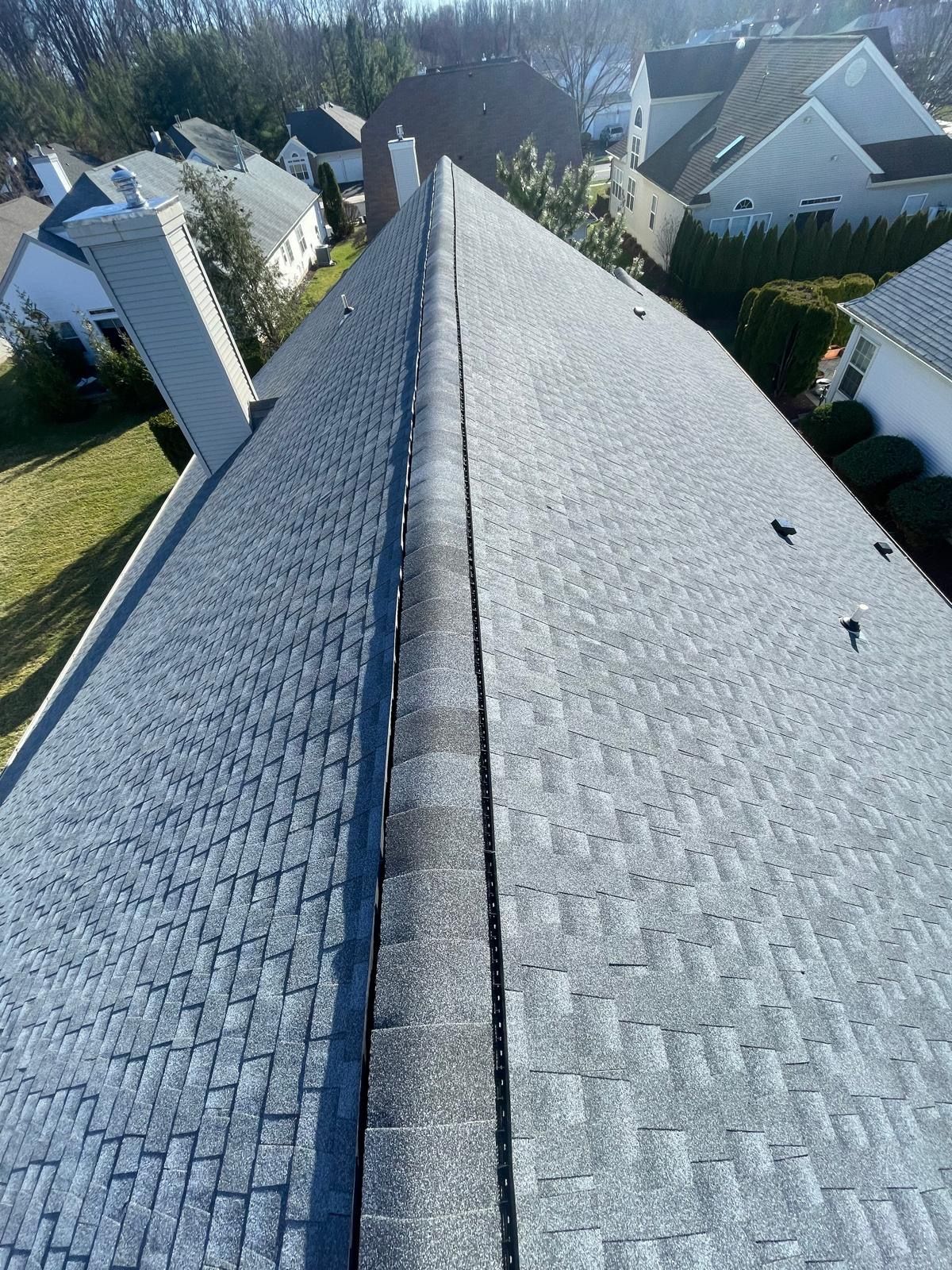 An aerial view of a roof with houses in the background