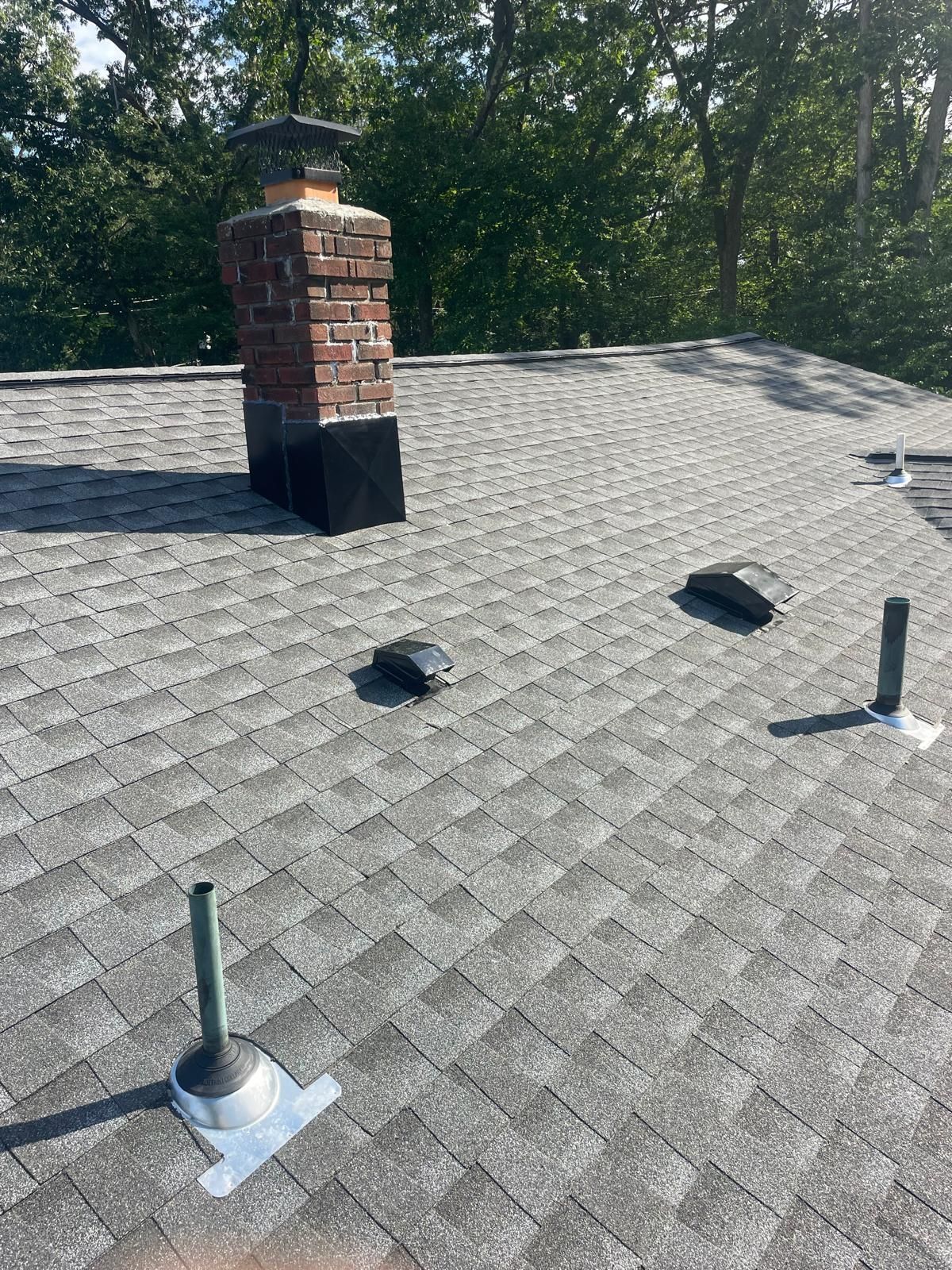 There is a chimney on the roof of a house.
