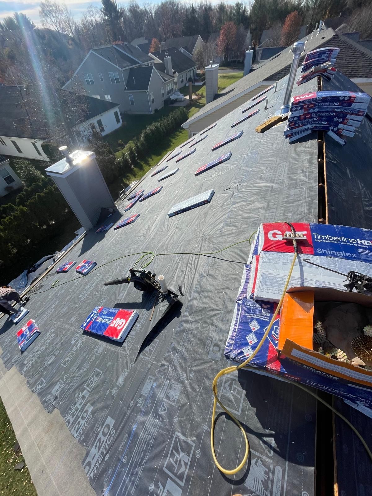 A roof with a lot of tools on it is being worked on.