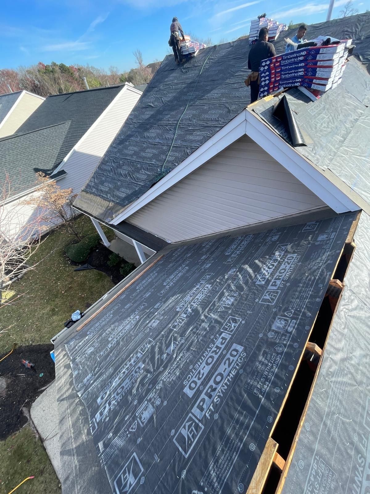A man is working on the roof of a house.