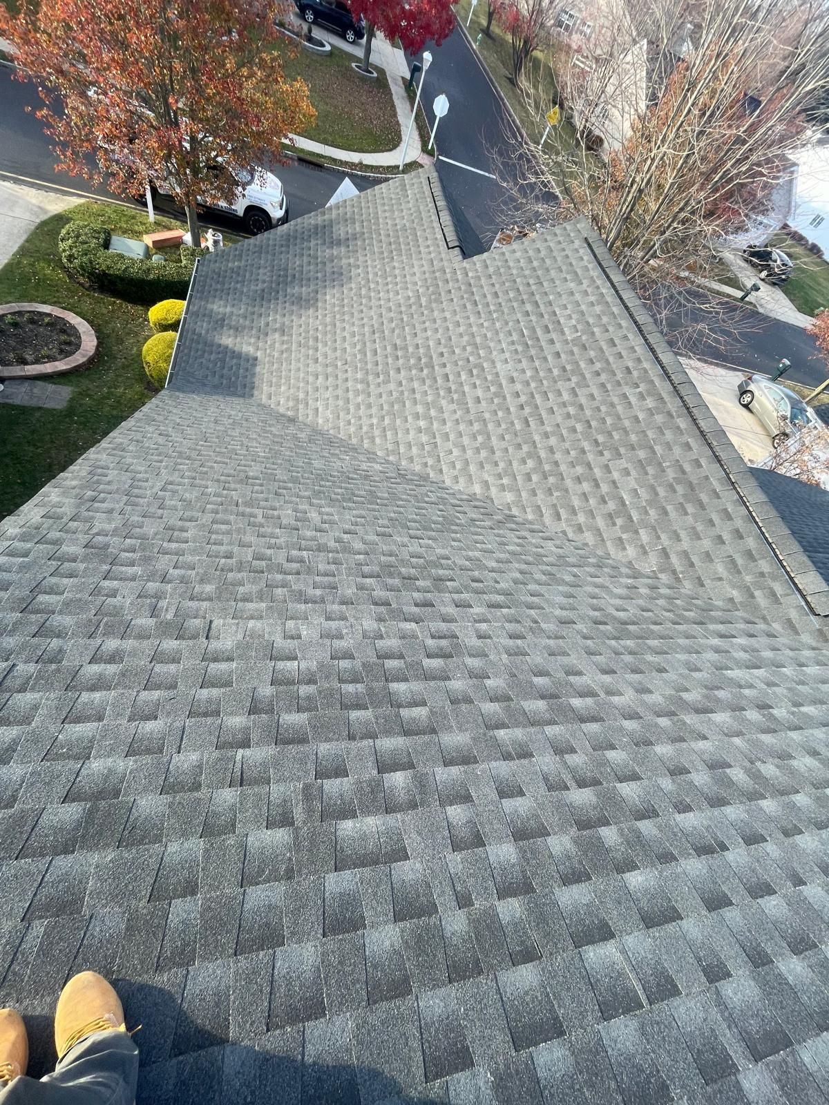 A person is standing on the roof of a house.