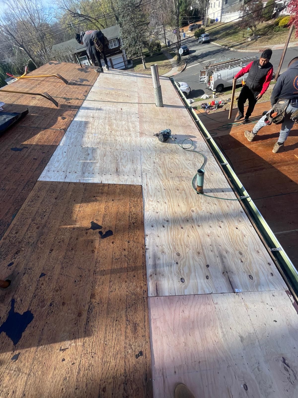 A group of people are working on a roof.