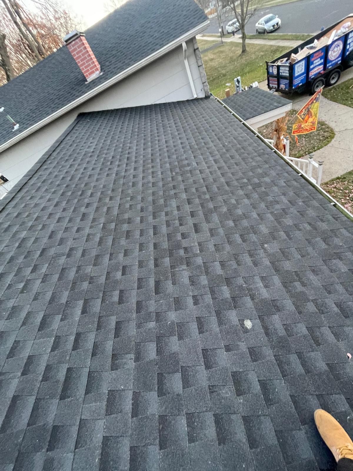 A person is standing on the roof of a house.