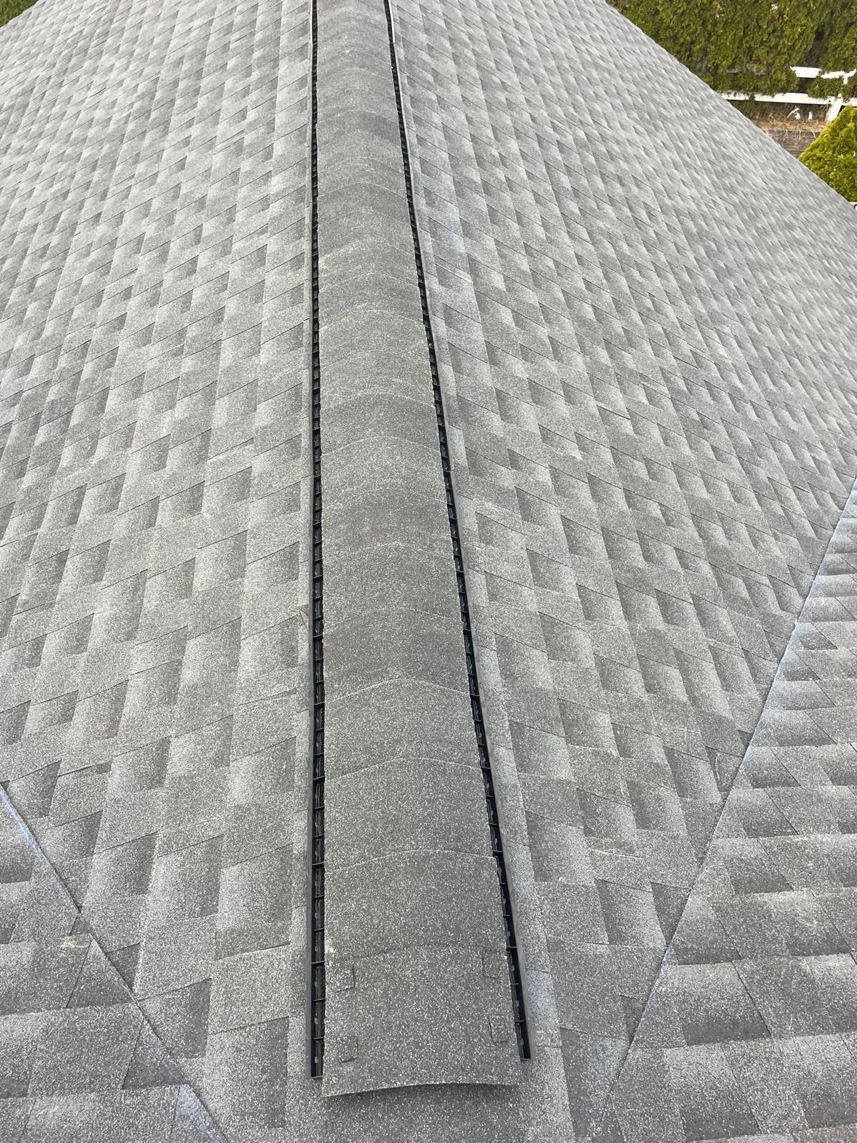 A close up of a roof with a drain on it.