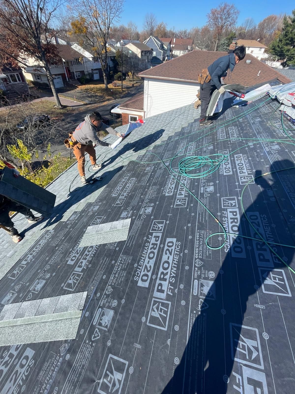 A group of people are working on a roof.
