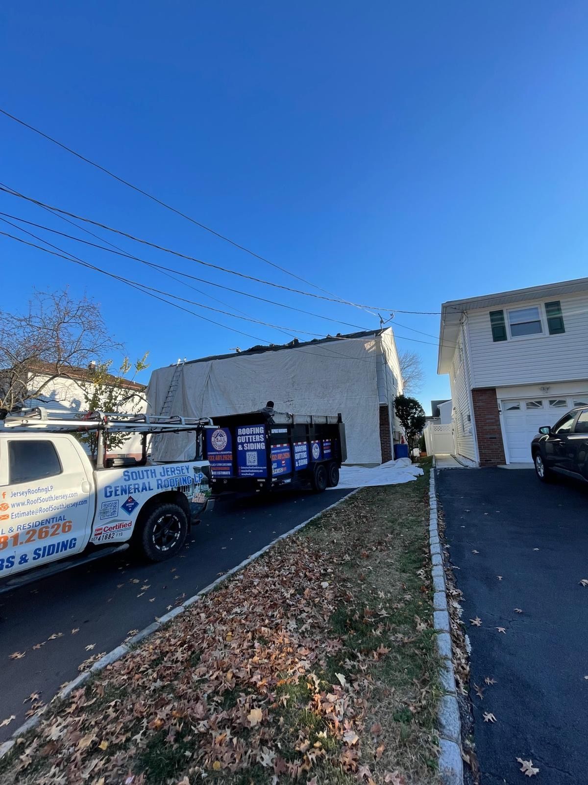 A white truck is parked in front of a house.