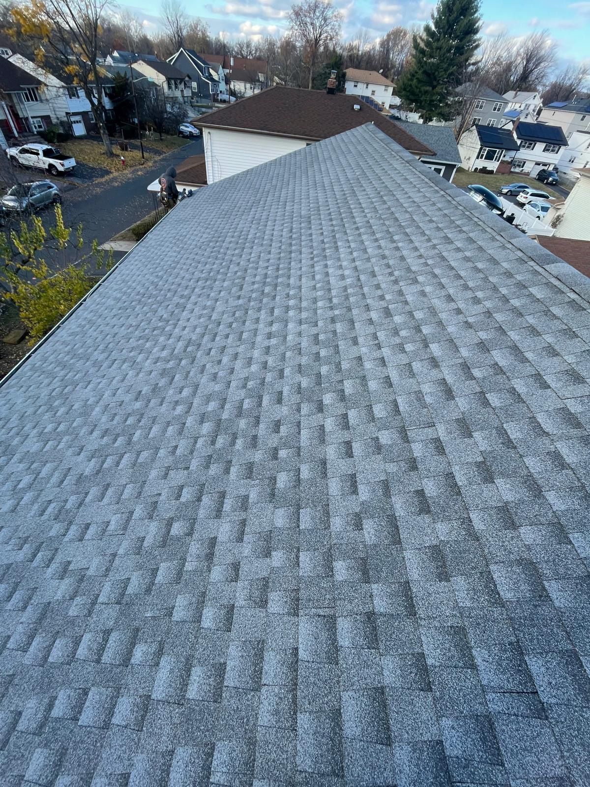 A roof with a lot of shingles and a lot of cars parked on it.